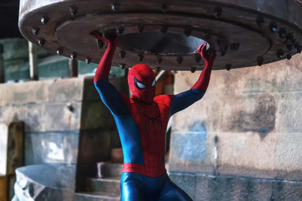 Spider-Man holding up a heavy object