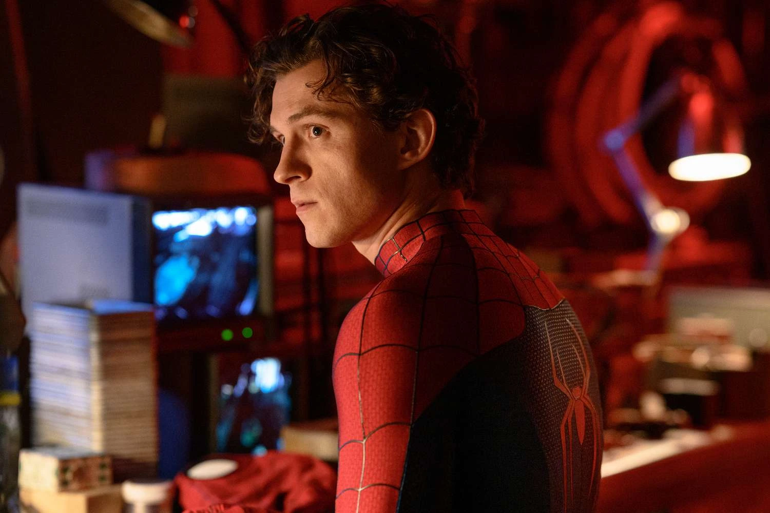 Peter at a workbench in his suit