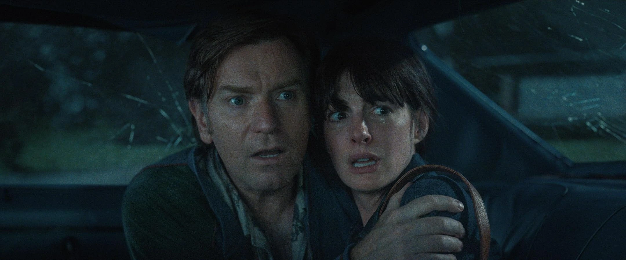 Greg and Denise holding each other in a car