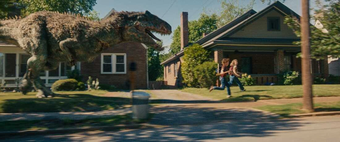 A dinosaur chasing Brian and Audrey in a frontyard
